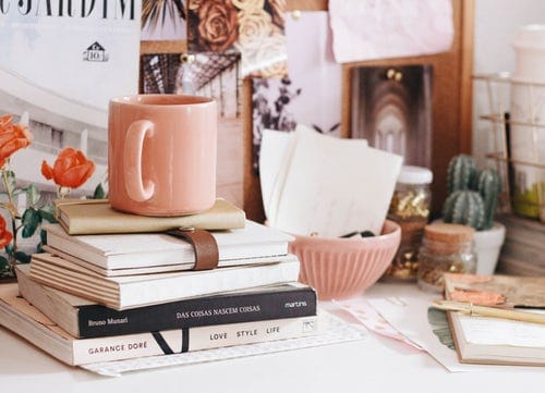 brown-ceramic-coffee-mug-on-book