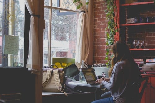 woman-using-computer-sitting-on-black-chair